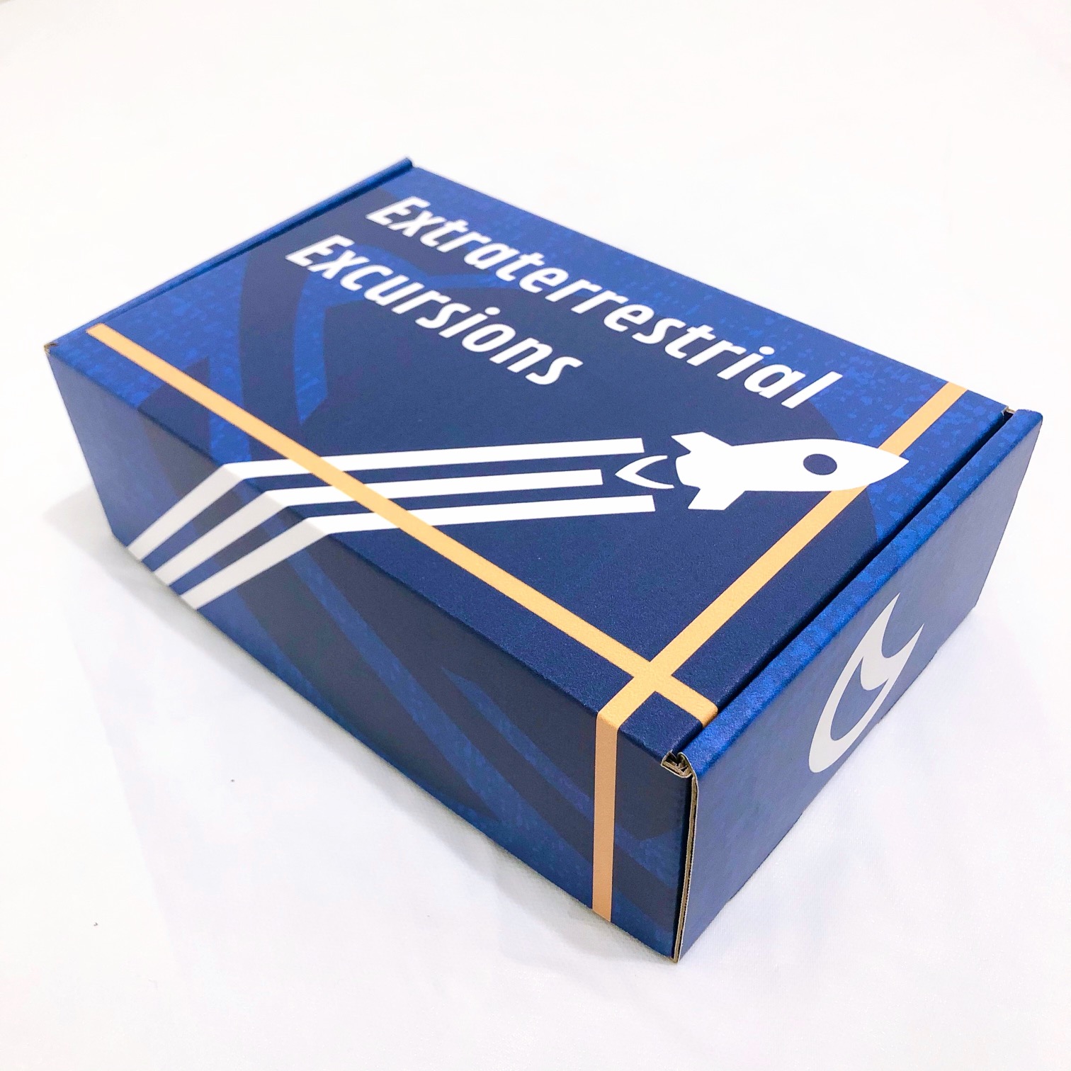 A right-angled shot of the front of a blue, space-themed mailer box.