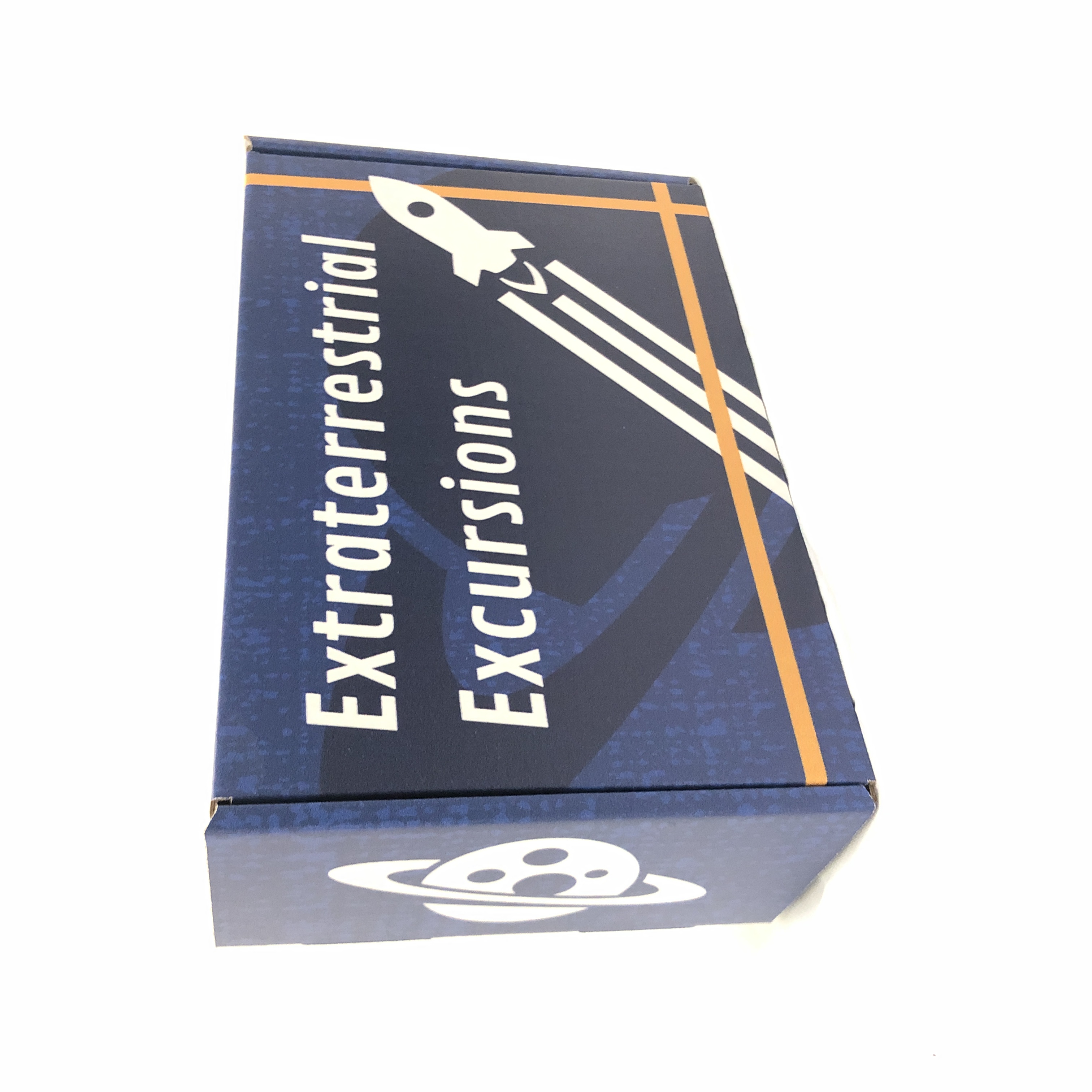 The top of a space-themed mailer box with a rocket ship flying in front of a planet.